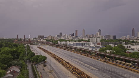 Atlanta-Georgia-Aerial-v910-flyover-Reynoldstown-across-O4W-and-Sweet-Auburn-capturing-Husley-Yard-military-transport-and-downtown-cityscape-with-stormy-sky---Shot-with-Mavic-3-Pro-Cine---May-2023