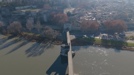 Aerial-establishing-shot-of-Pont-St-Bénézet-revealing-Palais-des-Papes
