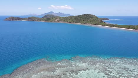 Aerial-view-of-Fiji-islands-nestled-in-the-heart-of-the-Pacific-Ocean-surrounded-by-pristine-waters-unveiling-the-mesmerizing-beauty-of-barrier-reef-corals