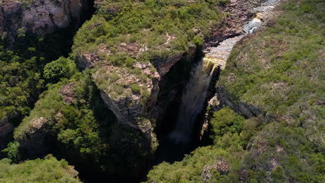 Aerial-view-of-a-waterfall-and-a-river-in-the-middle-of-a-big-vegetation,-Chapada-Diamantina,-Bahia,-Brazil