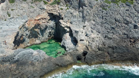 Green-Lake,-a-natural-sea-pool-on-a-rocky-seashore-in-Kithira,-Greece