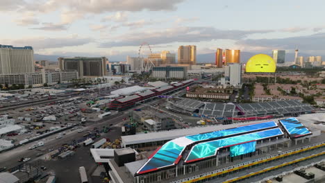 Aerial-view-backwards-over-the-Las-Vegas-Grand-Prix-track,-sunset-in-Nevada,-USA