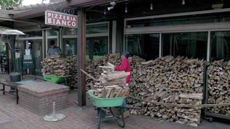 Wood-being-stacked-outside-Pizzeria-Bianco-Town-and-County-in-Phoenix,-Arizona