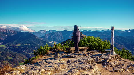 Hiker-taking-pictures-of-alpine-panorama-on-mountain-top,-timelapse