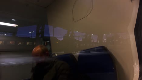 Abstract-pov-through-window-of-morning-train-leaving-in-twilight
