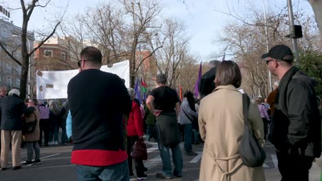 A-protestor-wears-a-Palestine-flag-as-he-walks-during-a-march-in-solidarity-with-Palestine