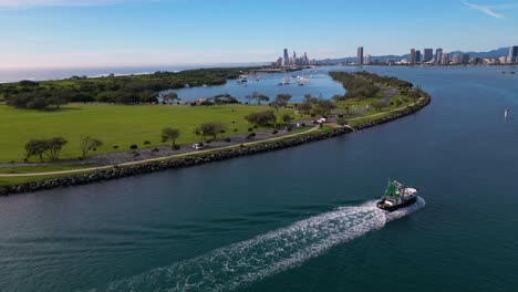 Aerial-views-over-the-Broadwater-following-a-trawler-moving-South-towards-Surfers-Paradise-on-the-Gold-Coast,-Australia