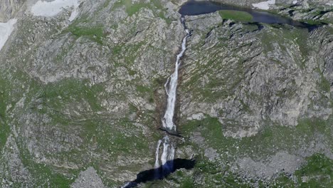 Cascata-di-stroppia-in-summer,-revealing-the-majestic-waterfall-and-rugged-terrain,-aerial-view