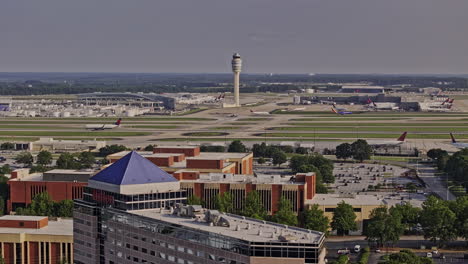 Atlanta-Georgia-Aerial-v936-drone-flyover-Hapeville-capturing-International-terminals-at-ATL-Hartsfield-airport-with-FAA-air-traffic-control-tower-and-Delta-HQ---Shot-with-Mavic-3-Pro-Cine---May-2023