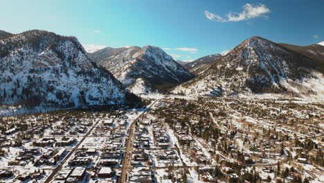 Winter-bluebird-sky-daytime-noon-snowy-downtown-Frisco-aerial-drone-high-altitude-main-street-Colorado-mountain-ski-town-Copper-Ikon-Pass-Breckenridge-Silverthorne-Dillon-Summit-County-left-circle