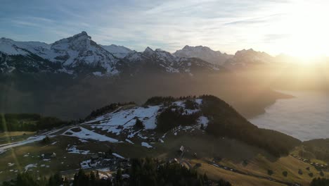 Amden-Weesen-Switzerland-sunny-light-hitting-lens-flight-way-above-clouds-in-the-Alps