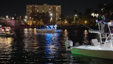 People-Celebrating-the-Holidays-on-Boats-Covered-with-Bright-and-Colorful-Lights-in-a-Christmas-Boat-Parade,-Static-Shot