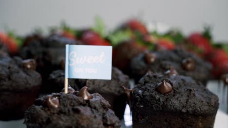 Nice-shot-of-Chocolate-covered-strawberries-and-beet-infused-muffins-spinning-on-a-lazy-susan-with-the-background-out-of-focus