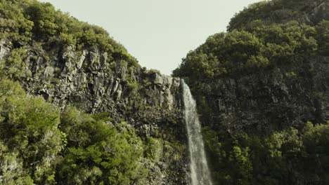 Drone-shot-moving-up-to-the-top-of-a-waterfall