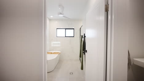 Modern-Bathroom-With-Large-Tub-And-Bamboo-Bathtub-Tray-on-Marbled-Walls