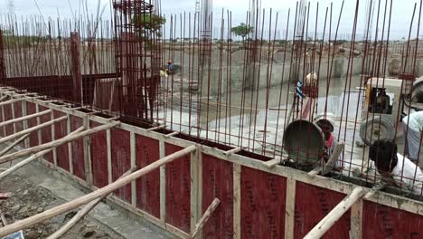 Construction-Labour-filling-Beam-with-cement-and-concrete-at-the-construction-site