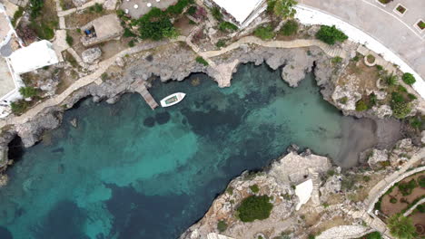 Aerial-top-view-of-Avlemonas-bay-swiming-area-with-crystal-clear-waters,-Kythira-Island,-Greece