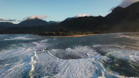 Overhead-view-of-drone-following-break-of-waves-on-Hawaii-coast,-aerial