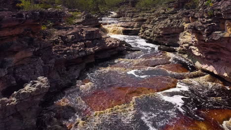 Aerial-view-of-a-waterfall-and-a-river-in-the-middle-of-a-big-vegetation,-Chapada-Diamantina,-Bahia,-Brazil