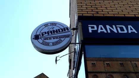 Closeup-sign-of-Panda-Restaurant-logo-Sushi---Burger-in-Dublin,-Ireland,-day