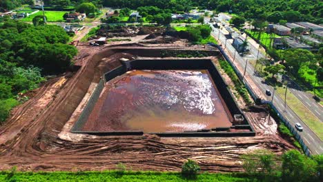 Drone-captures-rain-reservoir-amidst-Campo-Grande,-MS-Brazil,-highlighting-the-need-for-nature-city-integration