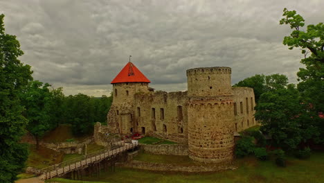 Drone-revealing-view-of-Cesis-Castle-on-a-cloudy-day-in-Latvia