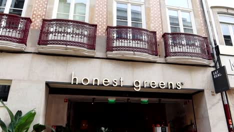 Honest-Greens-Restaurant-on-ground-floor-of-building-with-iconic-Portuguese-tiled-facade-and-balconies