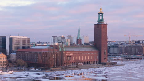 Red-brick-Stockhom-city-hall-with-unique-lantern-topped-tower,-aerial