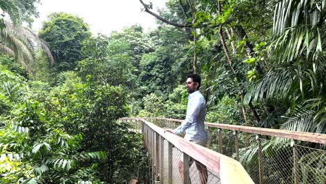 Man-In-Blue-Long-Sleeves-At-The-Boardwalk-Of-Windsor-Nature-Park,-Singapore