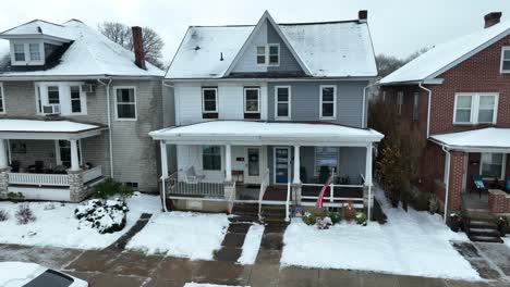 Waving-american-flag-in-front-of-house-in-neighborhood