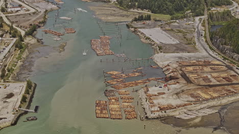 Squamish-BC-Canada-Aerial-v2-birds-eye-view-flyover-Mamquam-Blind-Channel,-tilt-up-capturing-the-town-of-outdoor-recreation-capital,-lush-forest-and-mountains---Shot-with-Mavic-3-Pro-Cine---July-2023