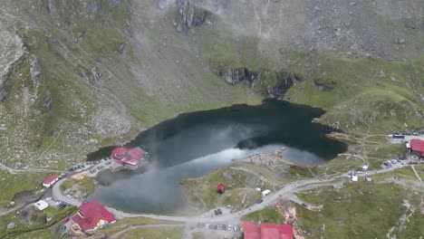 Lake-Balea-at-Transfagarasan-Mountain-Road-in-Carpathians,-Transylvania,-Romania,-Europe---Aerial-4k
