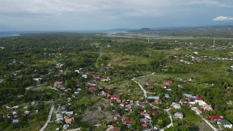 Moalboal,-philippines-showcasing-the-lush-landscape-and-residential-areas-in-daylight,-aerial-view