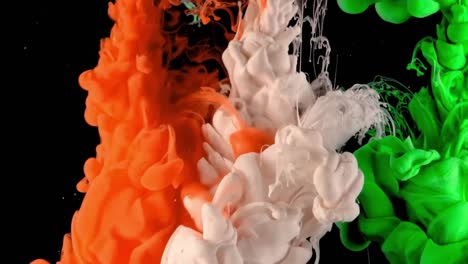 Tricolor-mixing-of-orange,-green-and-white-ink-drops-in-water