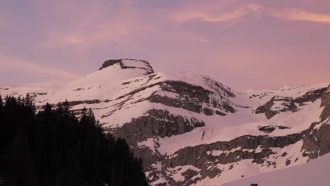 Witness-the-beauty-of-sunrise-over-a-snowy-mountain-range-through-this-mesmerizing-pink-clouds