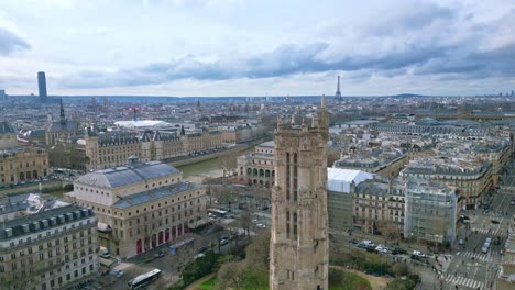 Saint-Jacques-Tower-and-square-near-Seine-river-with-Tour-Eiffel-in-background,-Boulevard-de-Sebastopol,-Paris-in-France