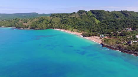 Wide-aerial-view-over-idyllic-Playa-Colorada-on-Las-Galeras-coastline,-Caribbean