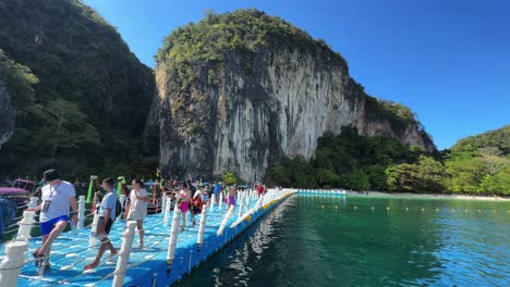 People-returning-to-boat-excursion-from-Hong-Island-Thailand-Krabi-background