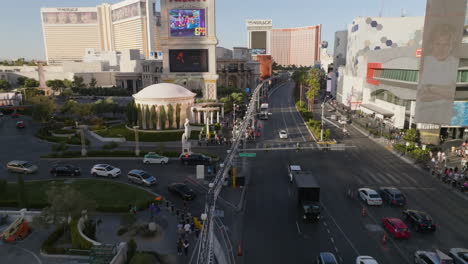 Drone-flying-low-over-the-strip,-Las-Vegas-Boulevard,-golden-hour-in-Nevada,-USA