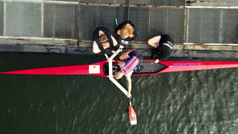 People-tuning-up-a-rowing-boat-for-training-on-the-river