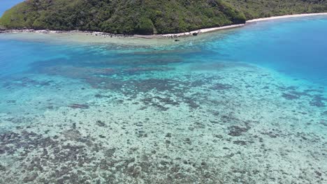 Descending-top-down-aerial-of-coral-reefs:-one-of-the-most-fascinating,-complex-and-biologically-diverse-ecosystems