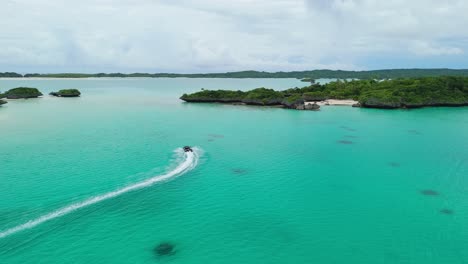 Tender-boat-going-towards-small-Fijian-island