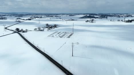 Path-in-snowy-rural-winter-landscape-and-farm-house-in-America