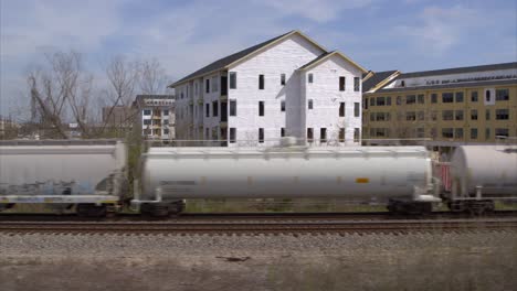 Drone-view-of-new-housing-construction-as-train-passes-by