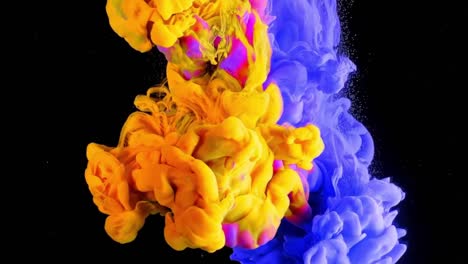 Pink,-blue-and-yellow-ink-splash-in-water