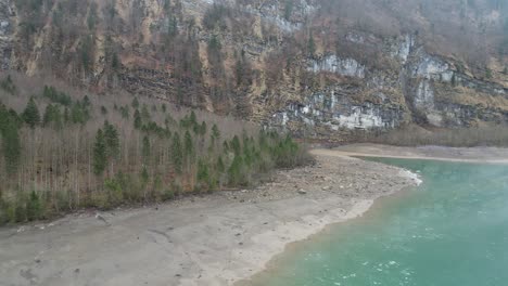 Klöntalersee-Glarus-Switzerland-lake-forest-and-mountain-face