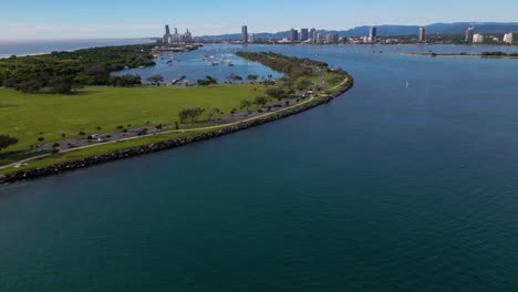 Rising-aerial-views-over-The-Spit-and-the-Broadwater-facing-South-towards-Surfers-Paradise-on-the-Gold-Coast,-Australia