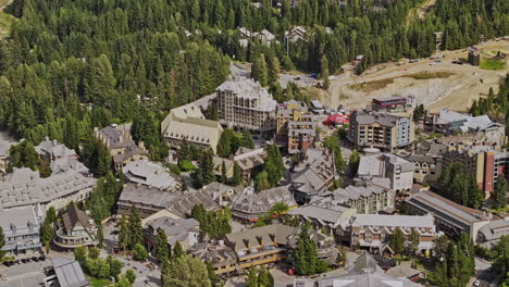 Whistler-BC-Canada-Aerial-v4-zoomed-birds-eye-view-drone-flyover-resort-village-town,-tilt-up-reveals-sliding-centre-at-Blackcomb-mountain-during-summer-season---Shot-with-Mavic-3-Pro-Cine---July-2023
