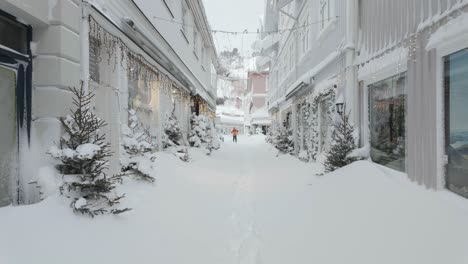 Man-Cross-Country-Skiing-In-Snow-Covered-The-City-Of-Kragero-After-Snowstorm-In-Norway