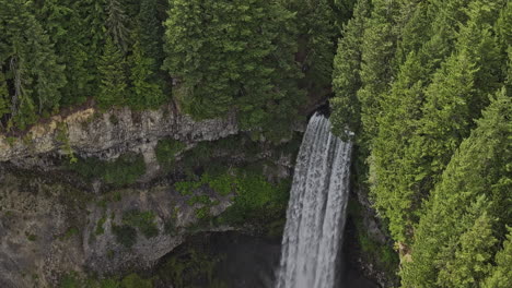 Brandywine-Falls-BC-Canada-Aerial-v4-zoomed-birds-eye-view-of-creek-cascade-over-a-rocky-cliff-into-a-deep-canyon-surrounded-by-lush-forest-in-provincial-park---Shot-with-Mavic-3-Pro-Cine---July-2023